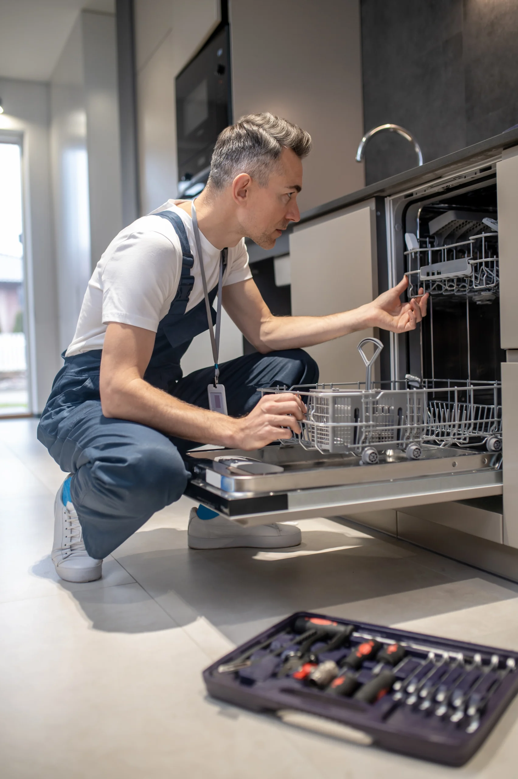 diagnostics-equipment-profile-serious-man-ooking-open-dishwasher-kitchen